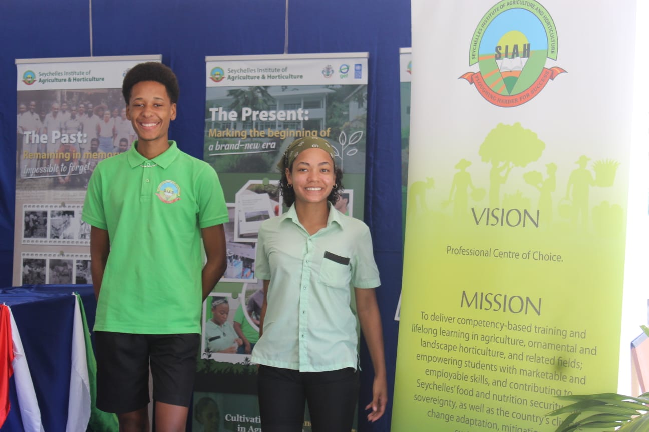 SIAH students in front of institute banners